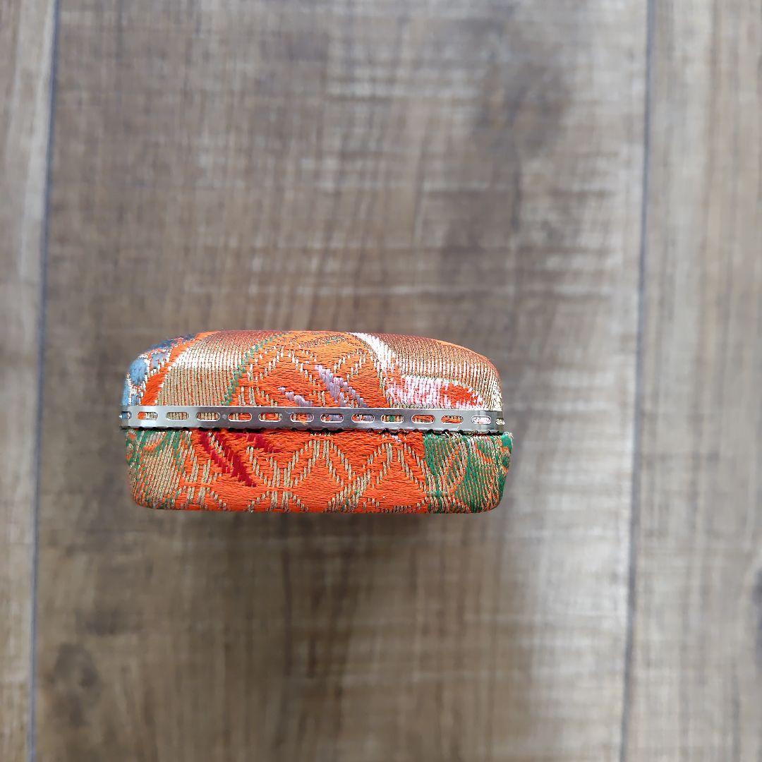 Case with orange pattern for Koto and 3 Koto picks
